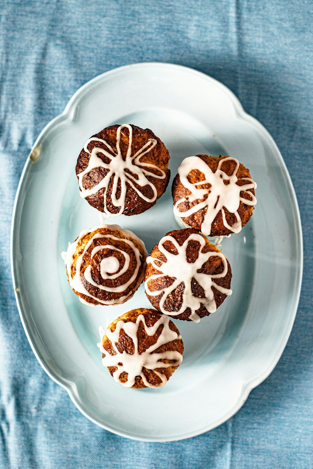 a white plate topped with cinnamon bundts covered in icing