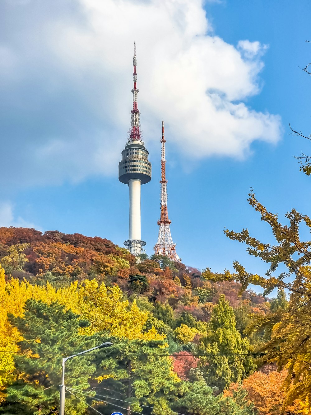 a tall tower with a sky scraper in the background