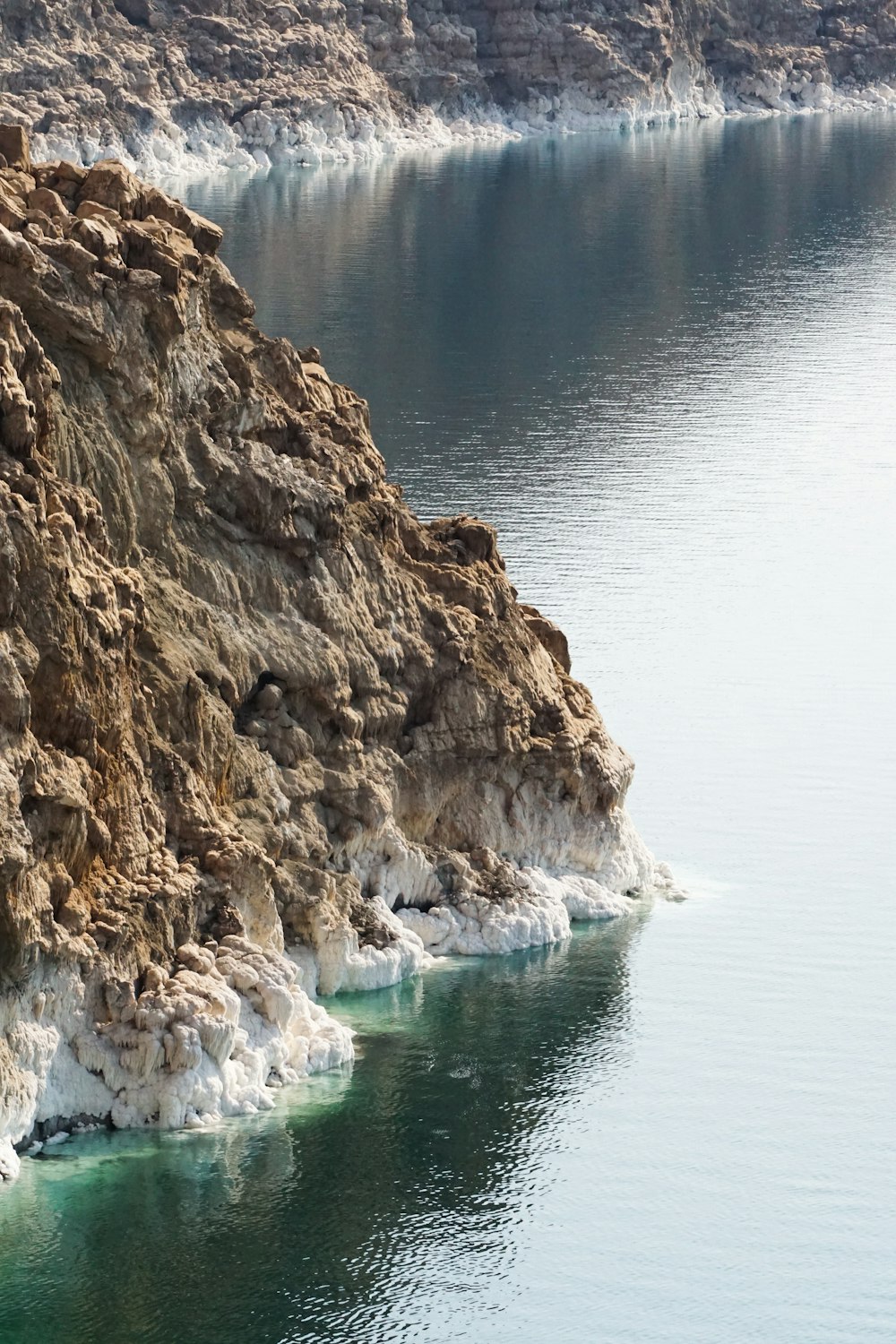 a large body of water surrounded by a rocky cliff