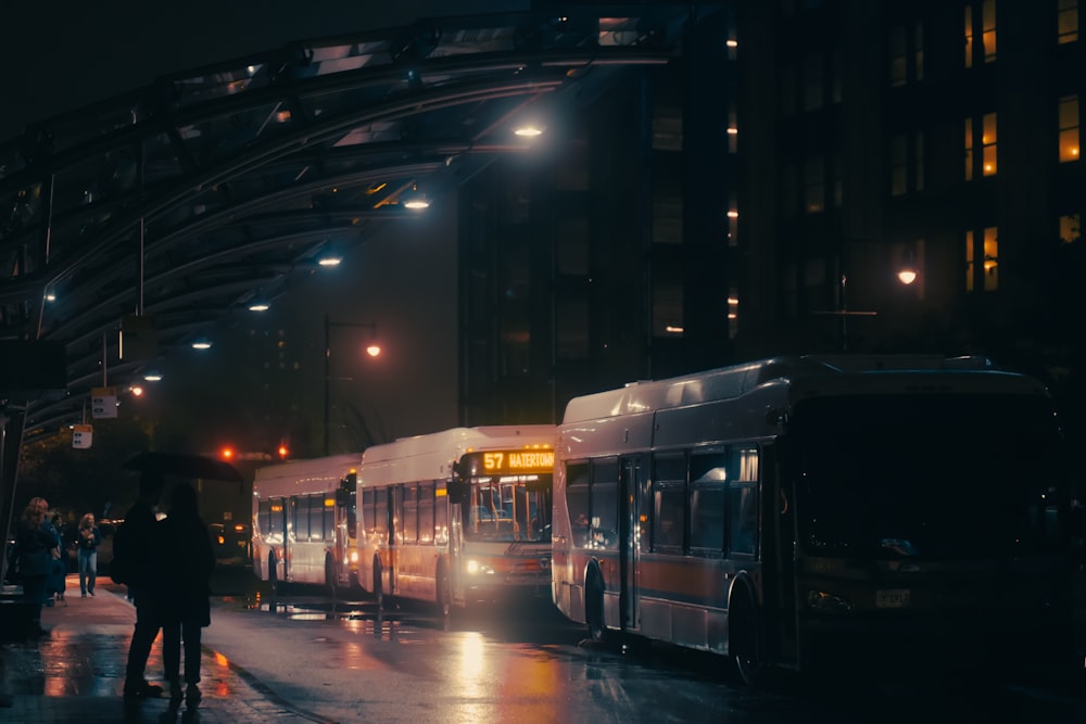 a couple of buses parked next to each other on a street