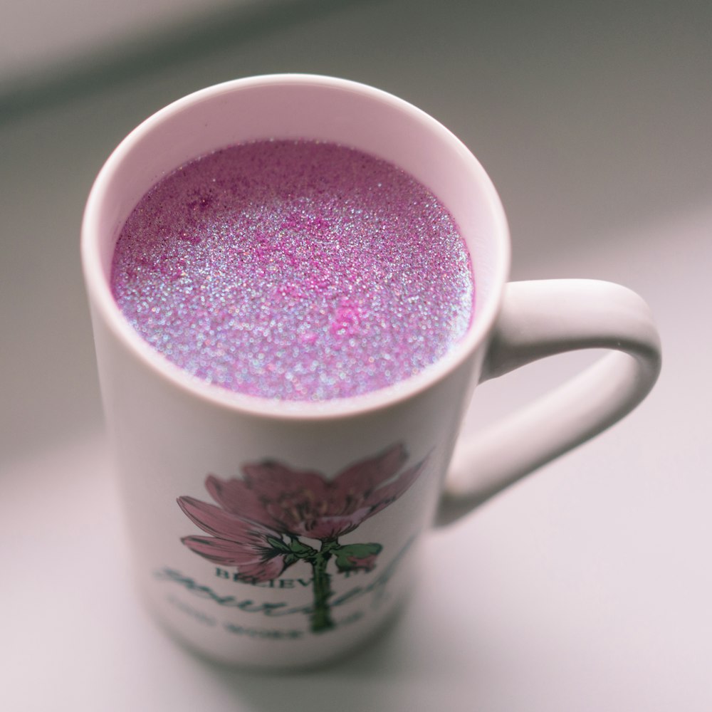 a cup filled with liquid sitting on top of a table