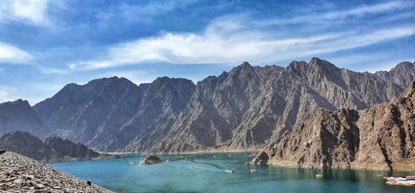 Turquoise reservoir surrounded by rocky mountains