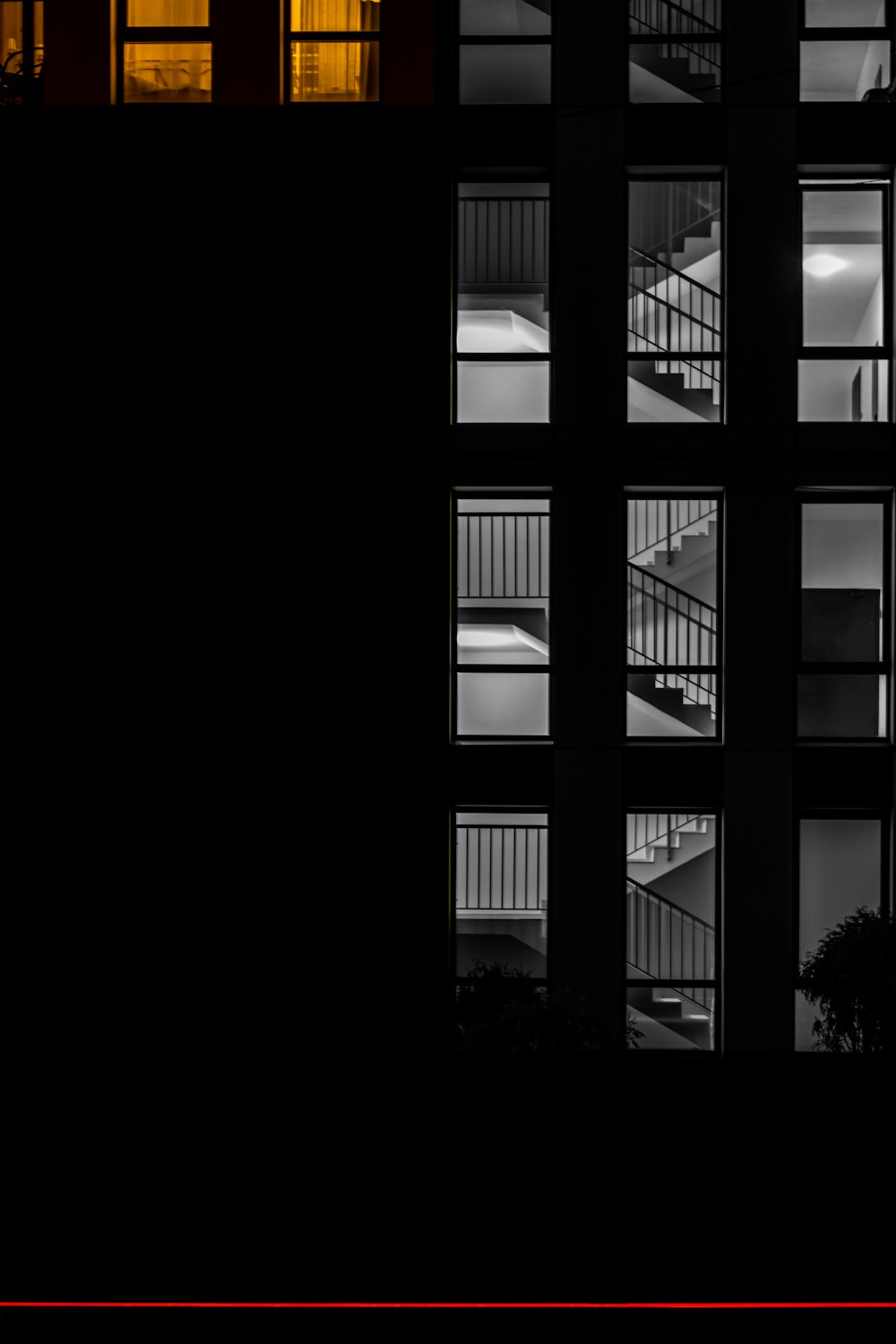 a black and white photo of a building at night