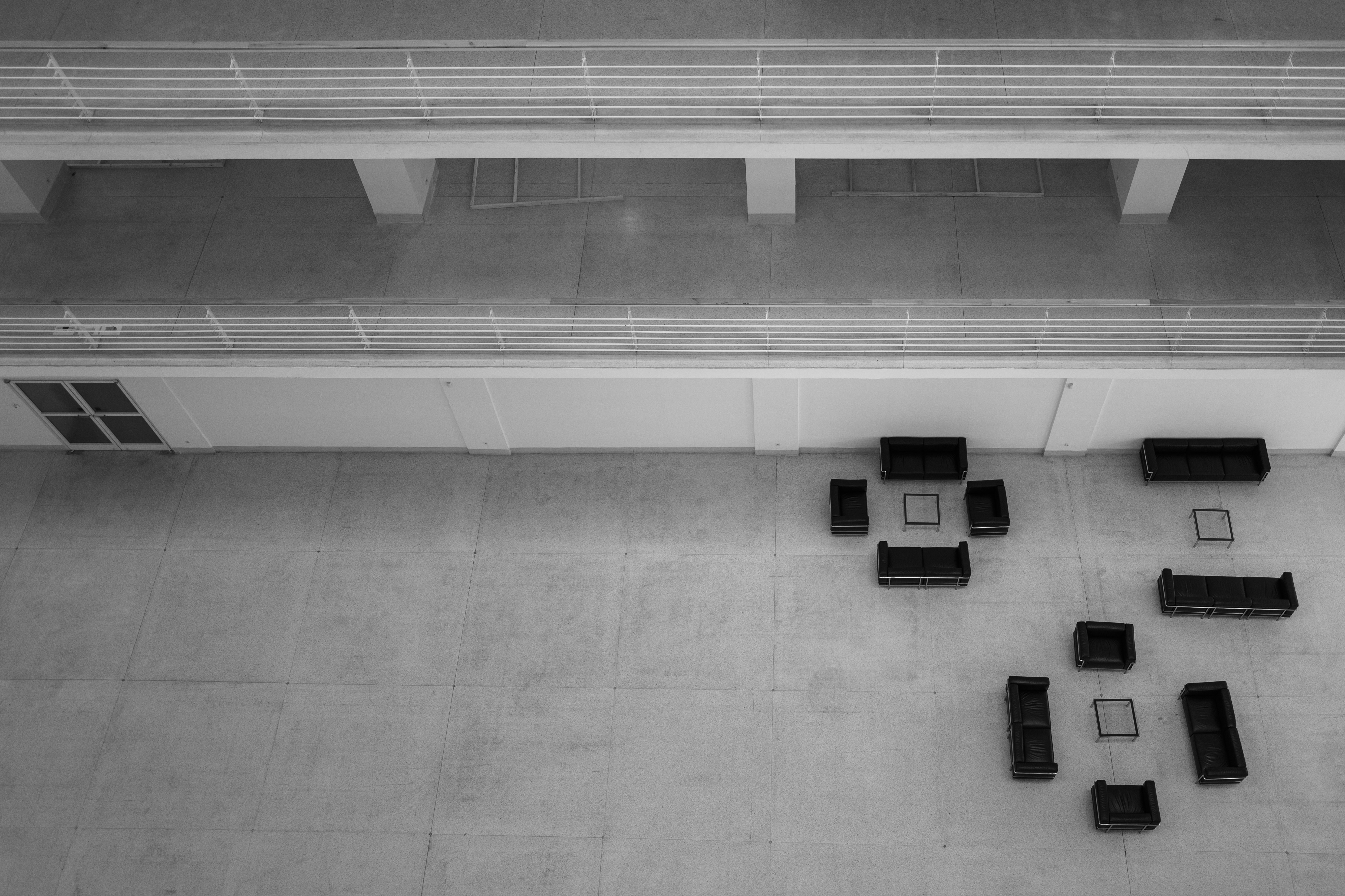 a black and white photo of a group of couches