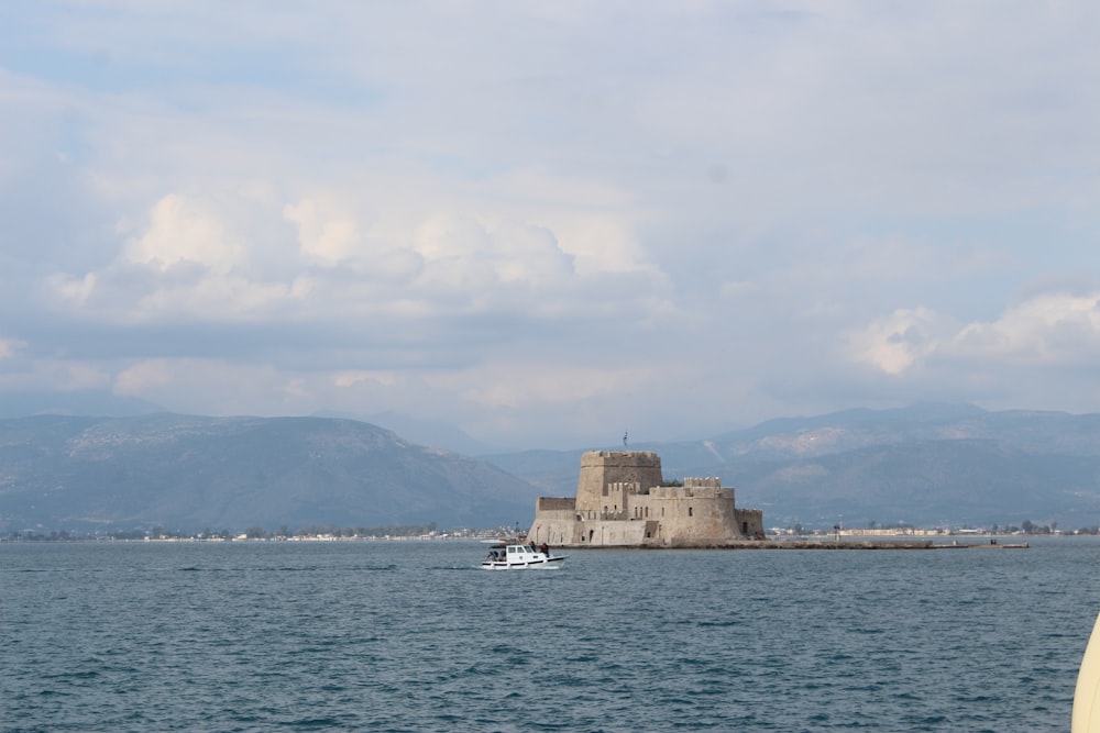 a boat in a body of water near a castle