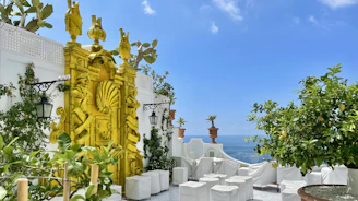 An elegant terrace overlooking Marbella’s luxury co-living spaces framed by lush greenery and ocean views.