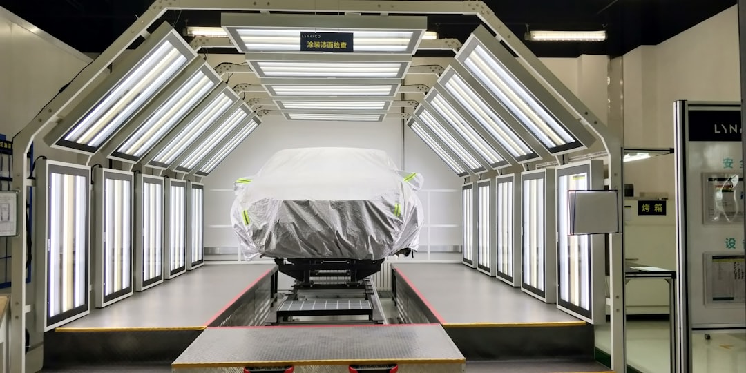 a car covered with a tarp is parked in a garage,