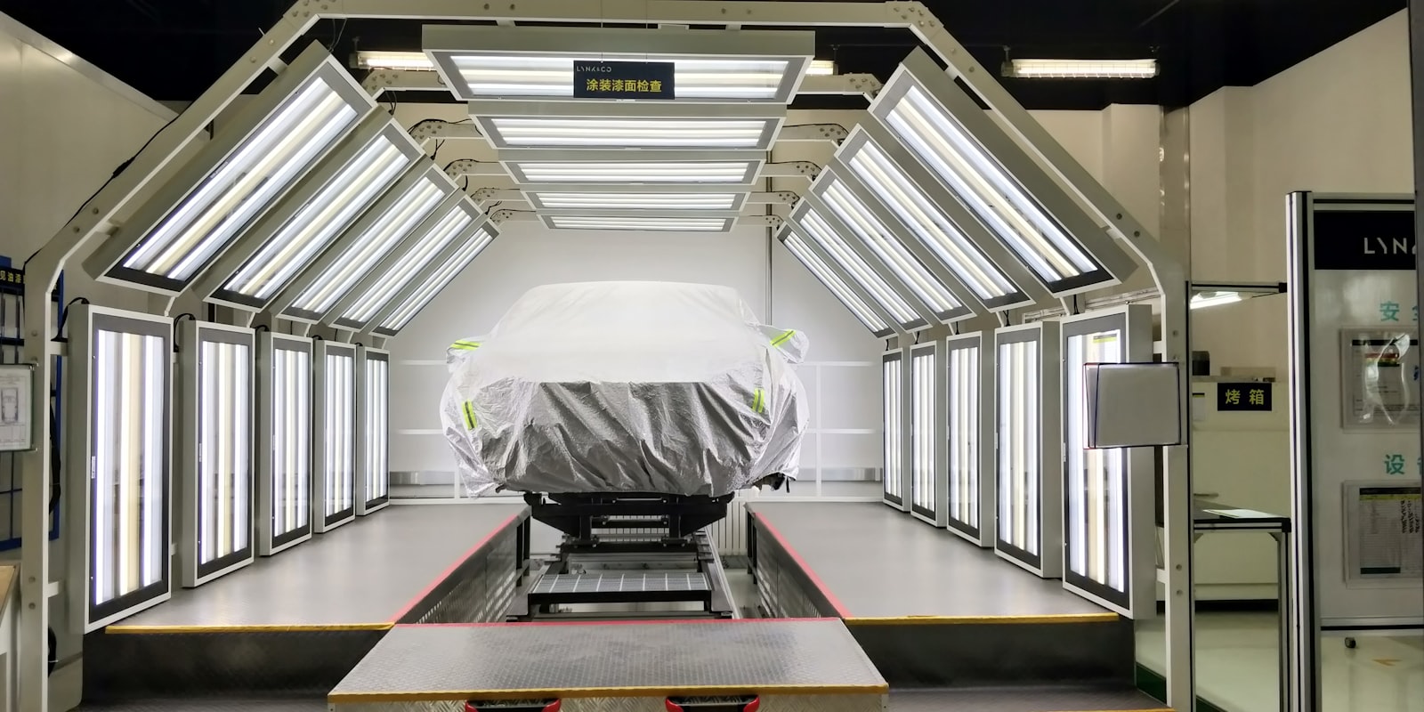 Professional auto paint booth with car being painted