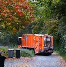 a garbage truck is parked on the side of the road