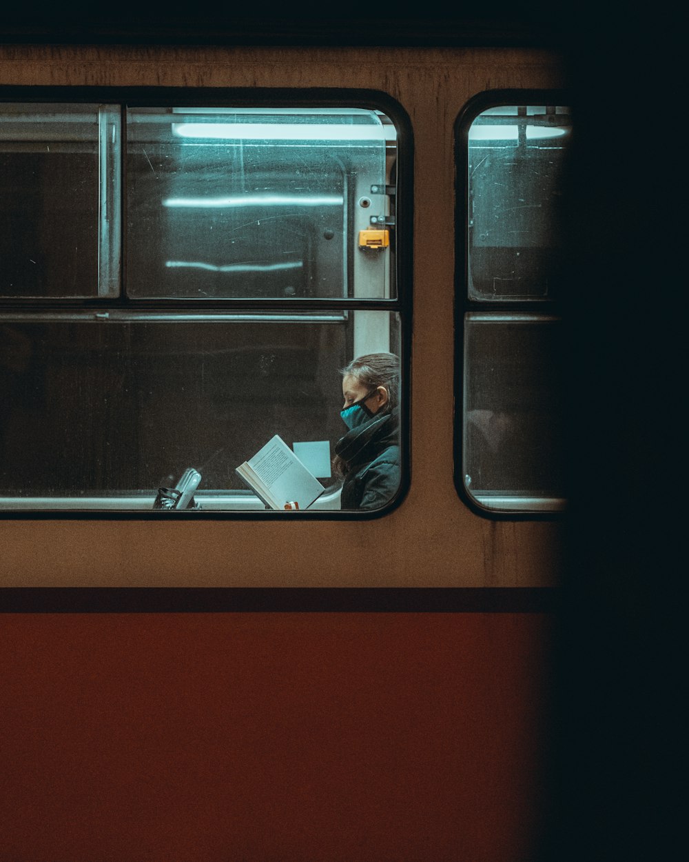 a man sitting in a train looking out the window