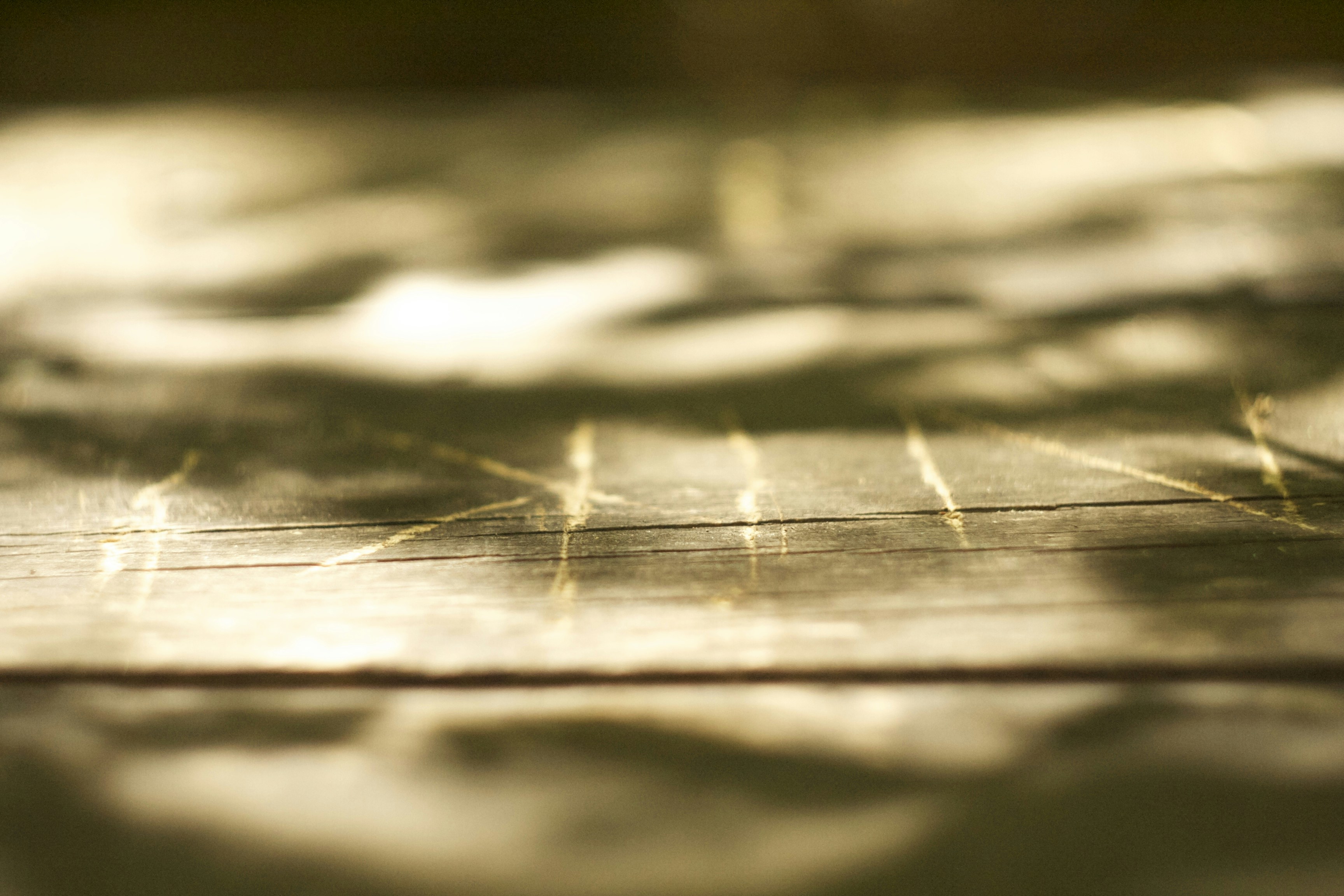 a close up of a wooden surface with a blurry background