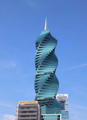 a tall building with a spiral design on top of it