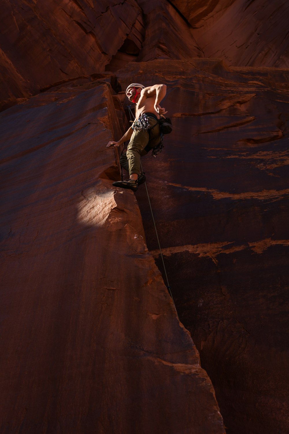 a man climbing up the side of a mountain