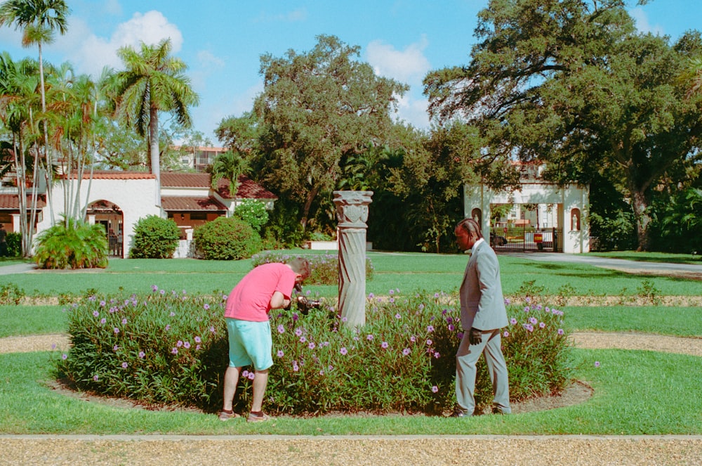 a couple of people that are standing in the grass