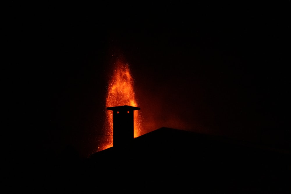 a fire hydrant spewing out water at night