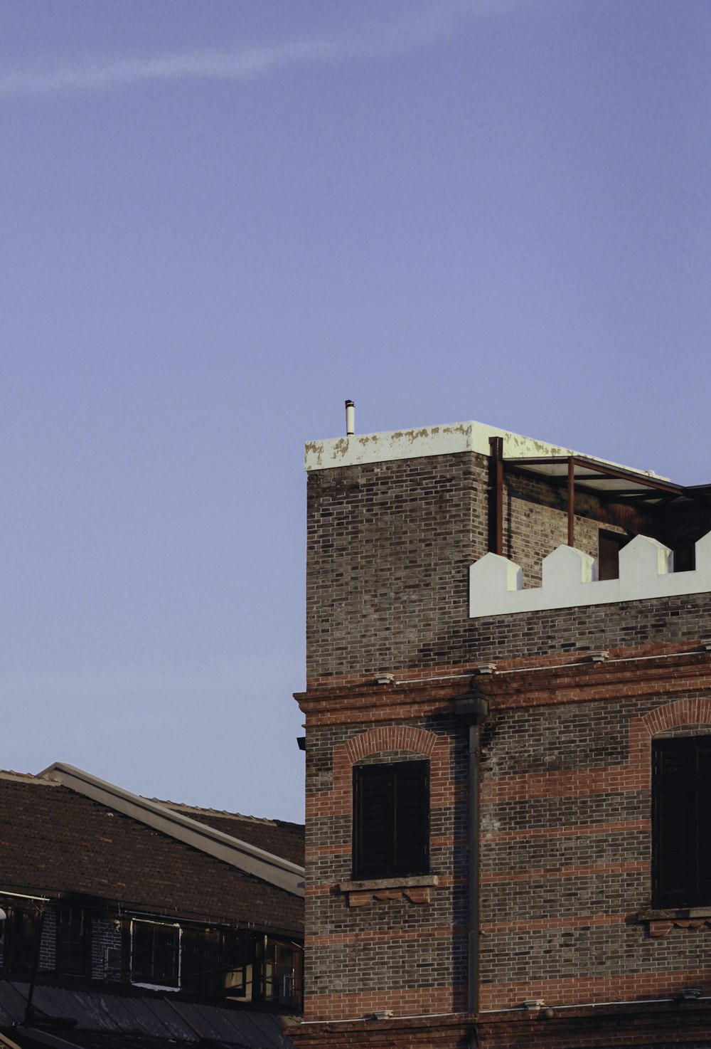 a tall brick building with a clock on it's side