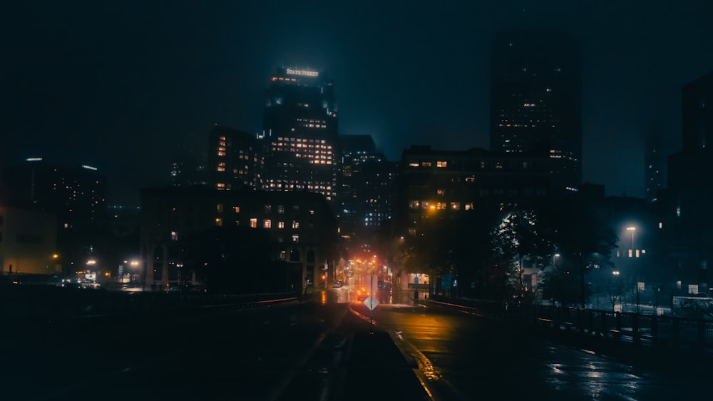 a city at night with a train on the tracks