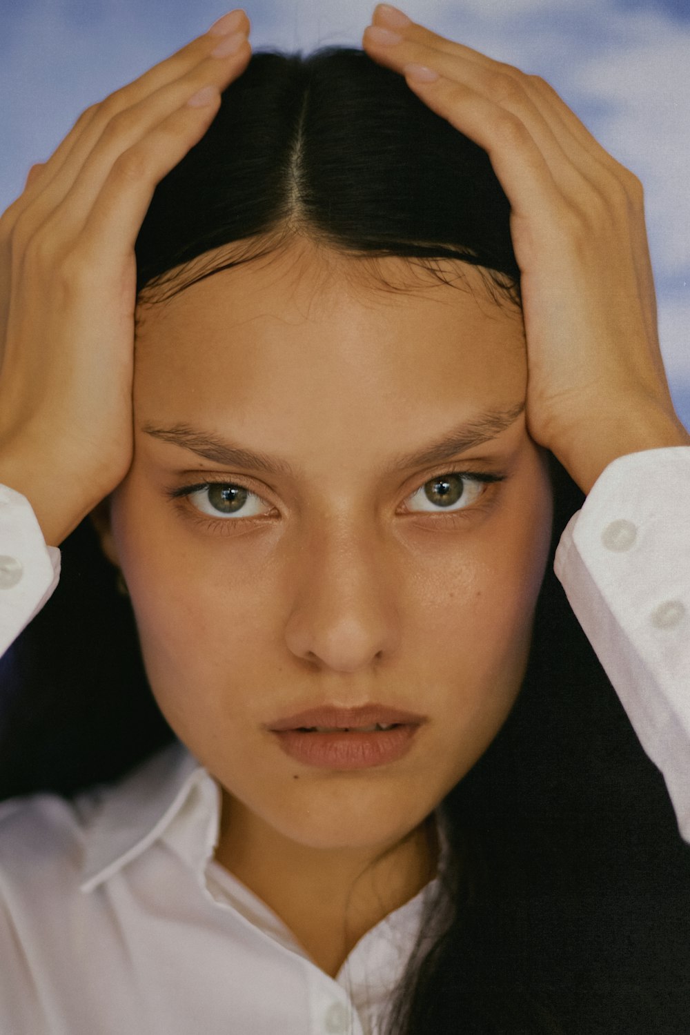 a woman with her hands on her head