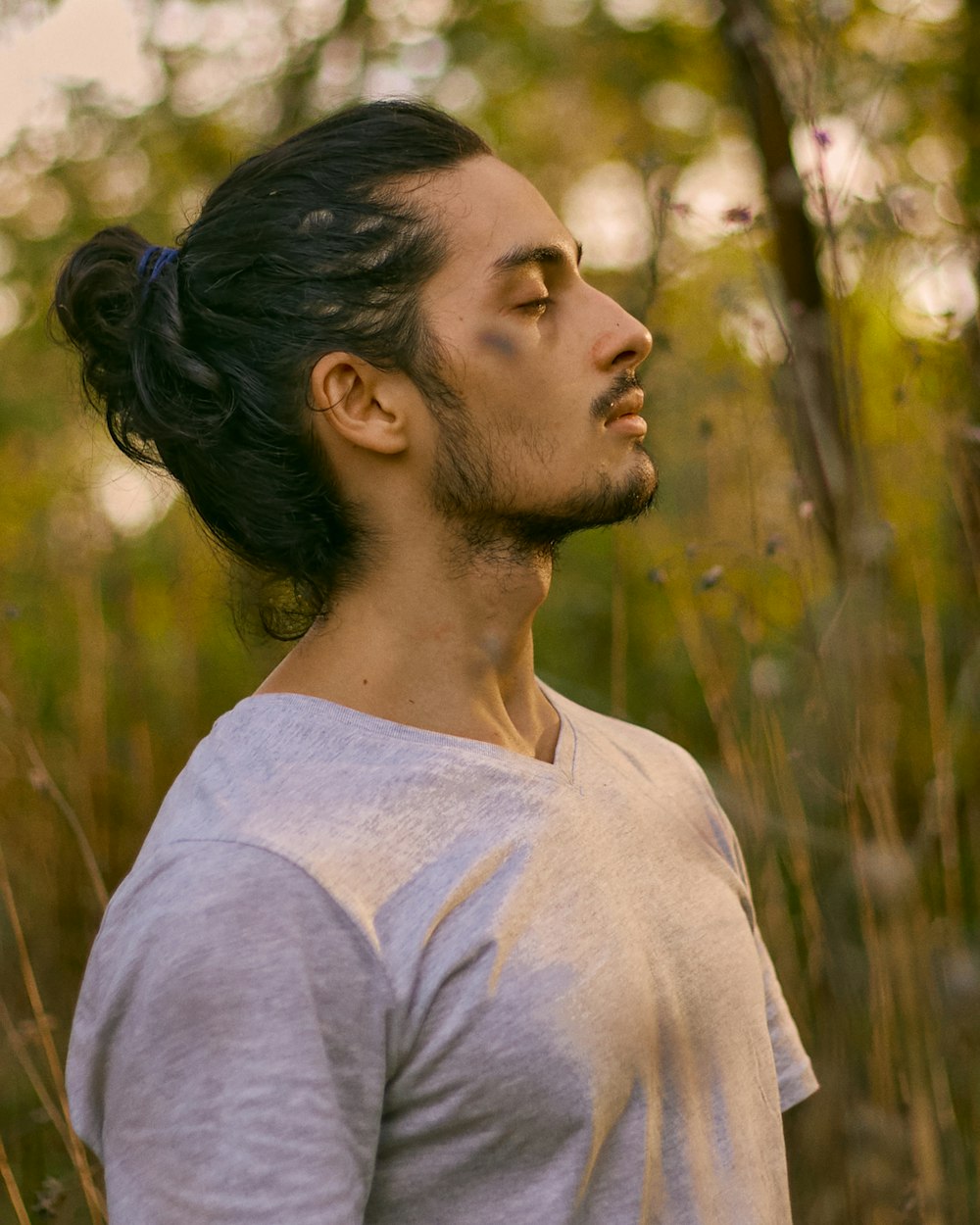 a man standing in a field of tall grass