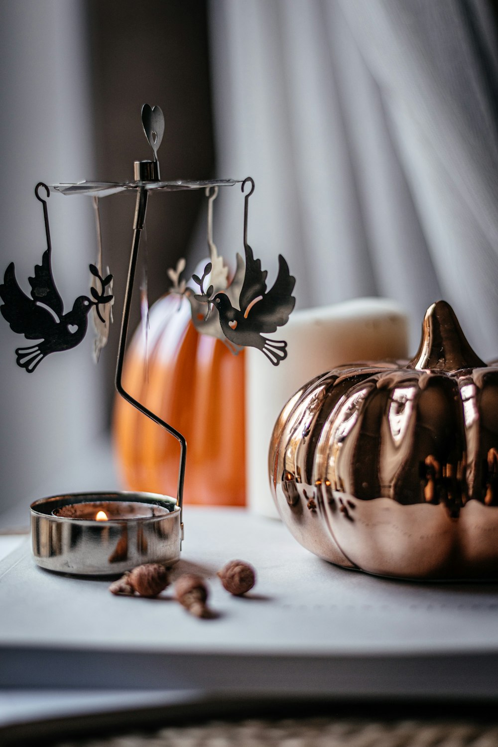 a table with a candle holder and a pumpkin