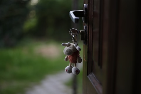 a key chain hanging from a door handle of a newly finished luxury home for a family