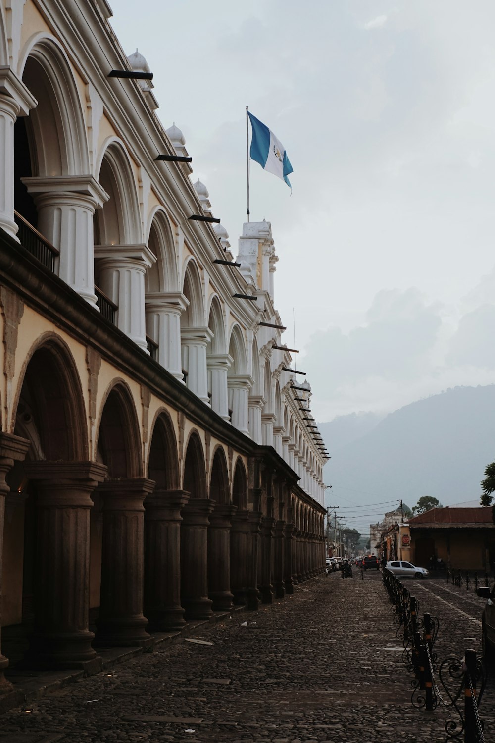 a row of buildings with a flag on top of it