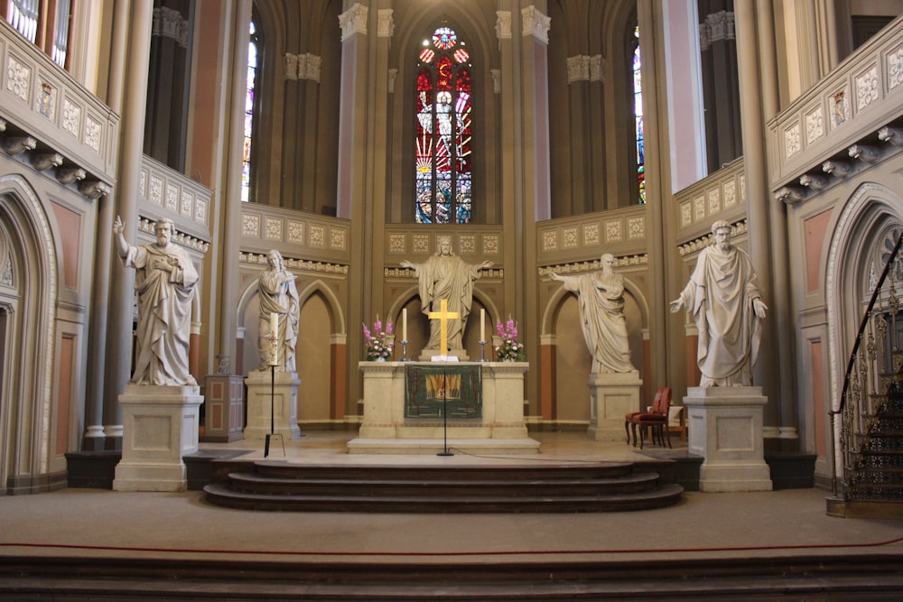 a church with a statue of a person in the middle of the alter