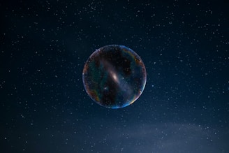 a large bubble floating in the air with stars in the background