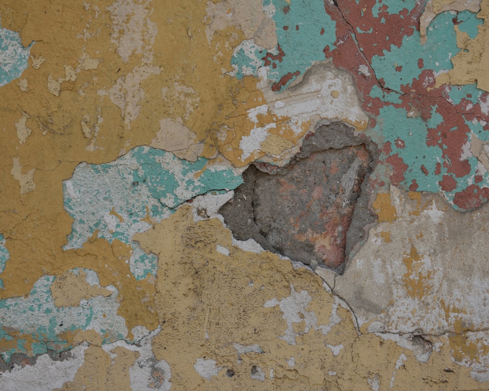a close up of a wall with peeling paint