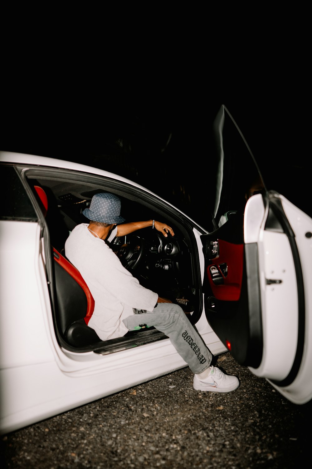 a man sitting in a car with his head out the window