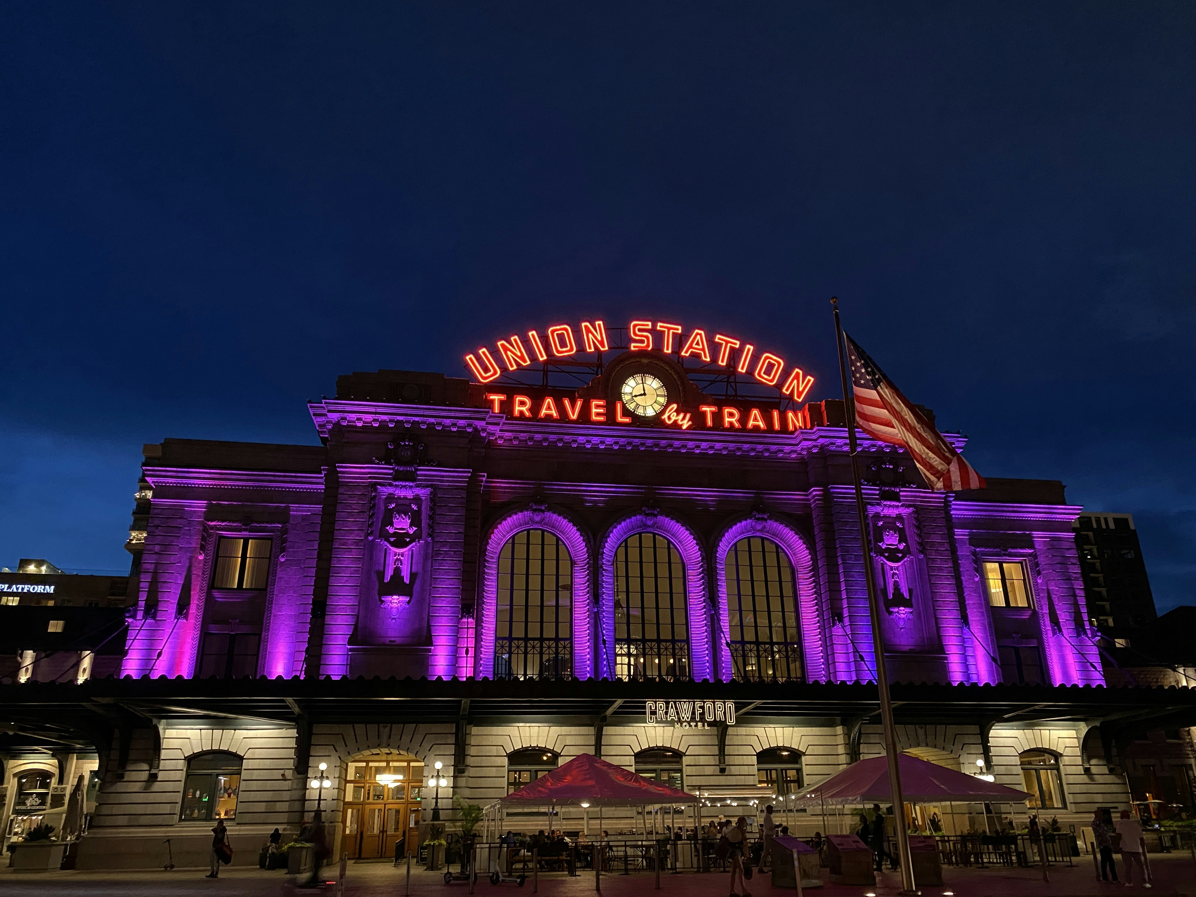 a train station lit up with purple lights