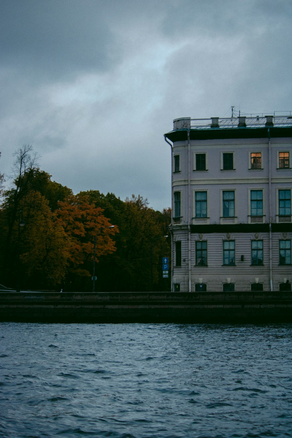 a large white building sitting next to a body of water