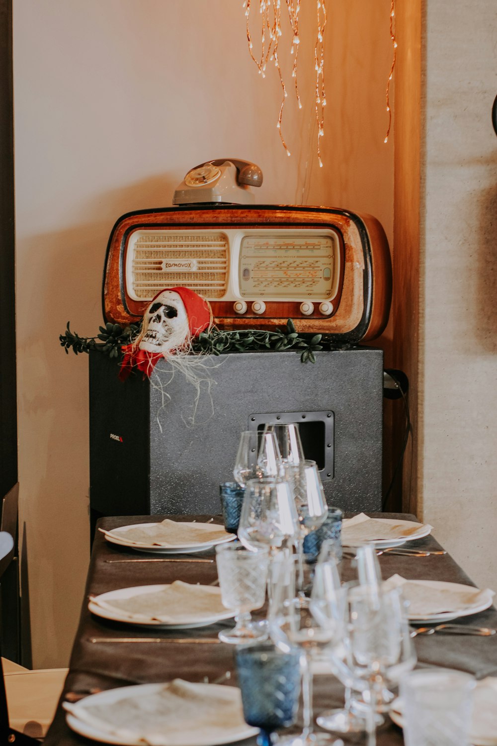 a table set for a dinner with a radio in the background