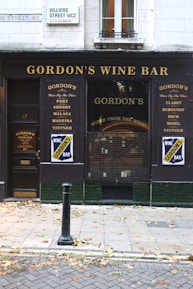 a store front with a sign for gordon's wine bar