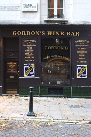 a store front with a sign for gordon's wine bar