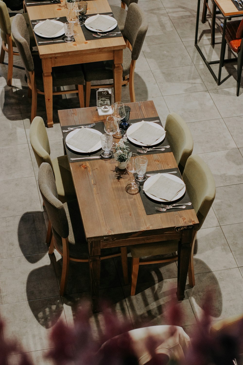 a restaurant with tables and chairs with place settings