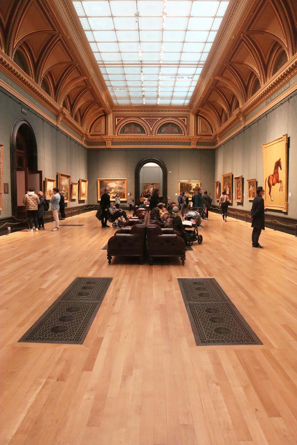 a large room filled with lots of paintings