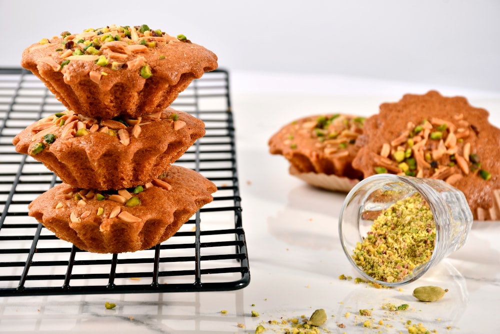 a stack of muffins sitting on top of a cooling rack