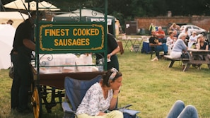 Happy customers enjoying bratwurst at a local festival.