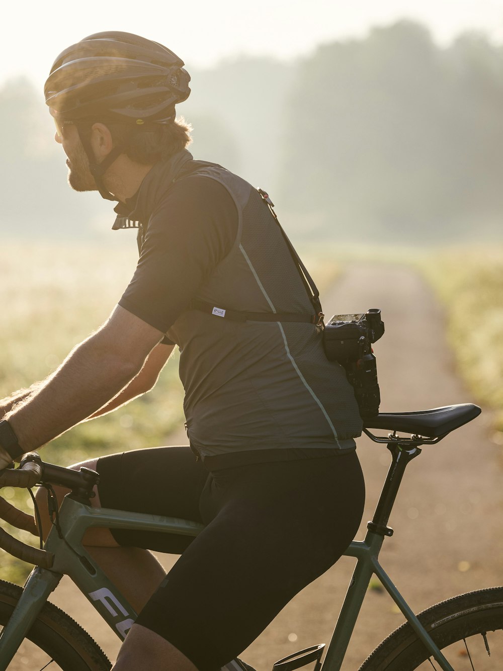 a man riding a bike down a dirt road