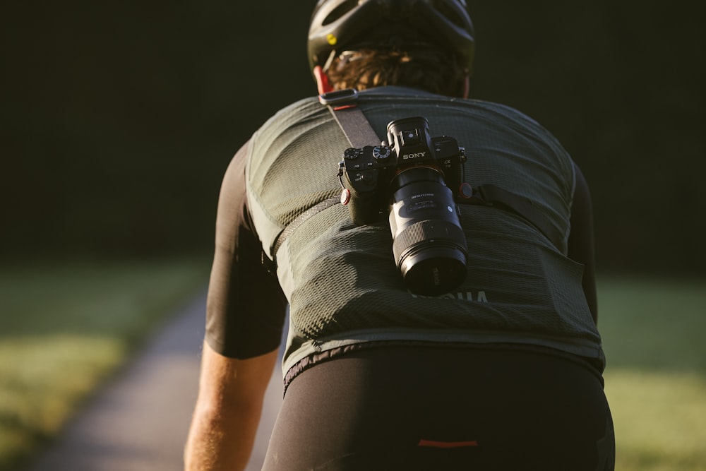 a man with a camera strapped to his back