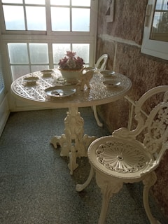 A beautifully crafted teakwood dining table set in a sunlit room.