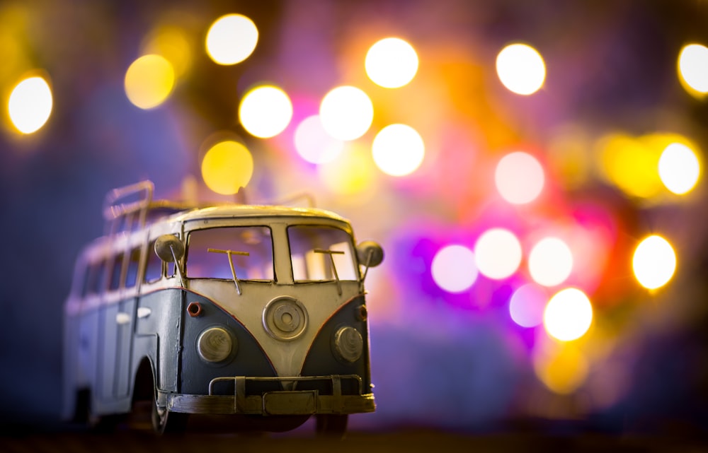 a toy bus sitting on top of a wooden table