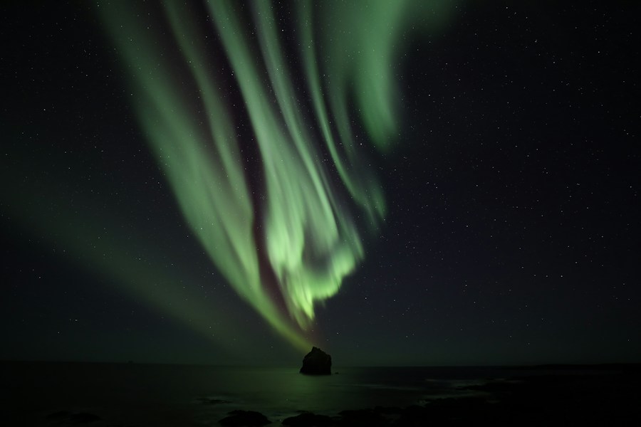 Northern lights over an Icelandic landscape