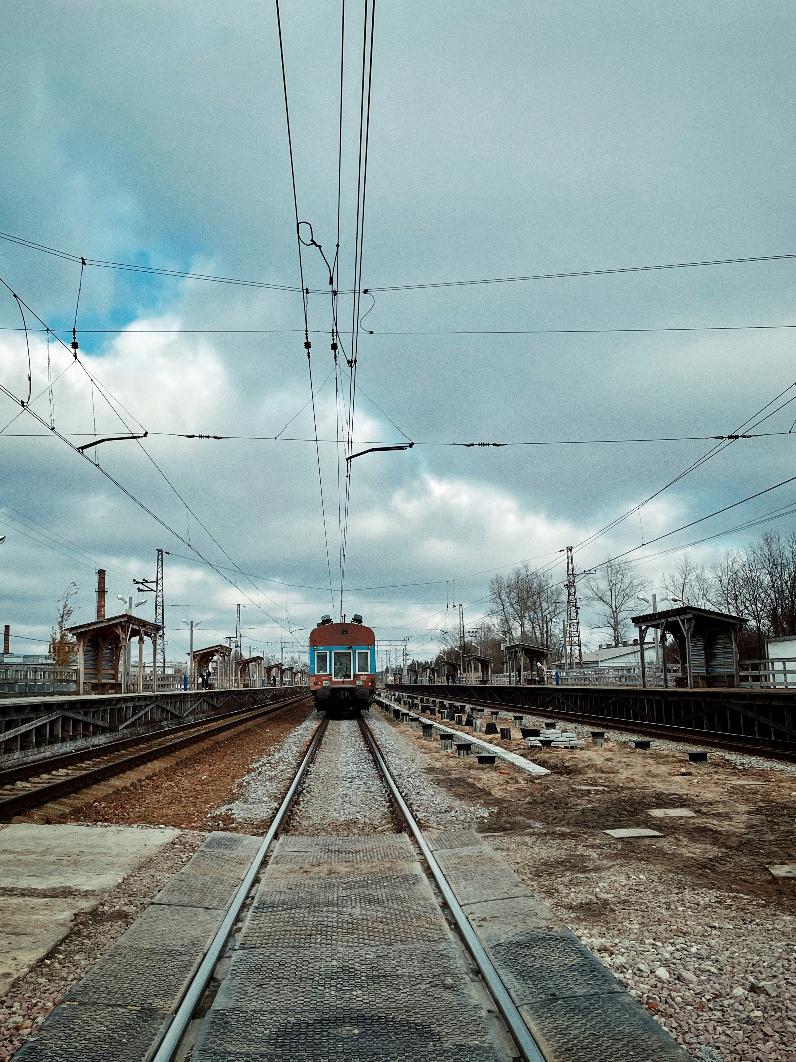 a train traveling down train tracks next to a train station