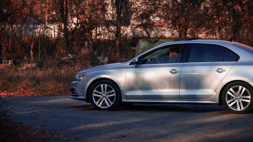 a silver car parked on the side of a road