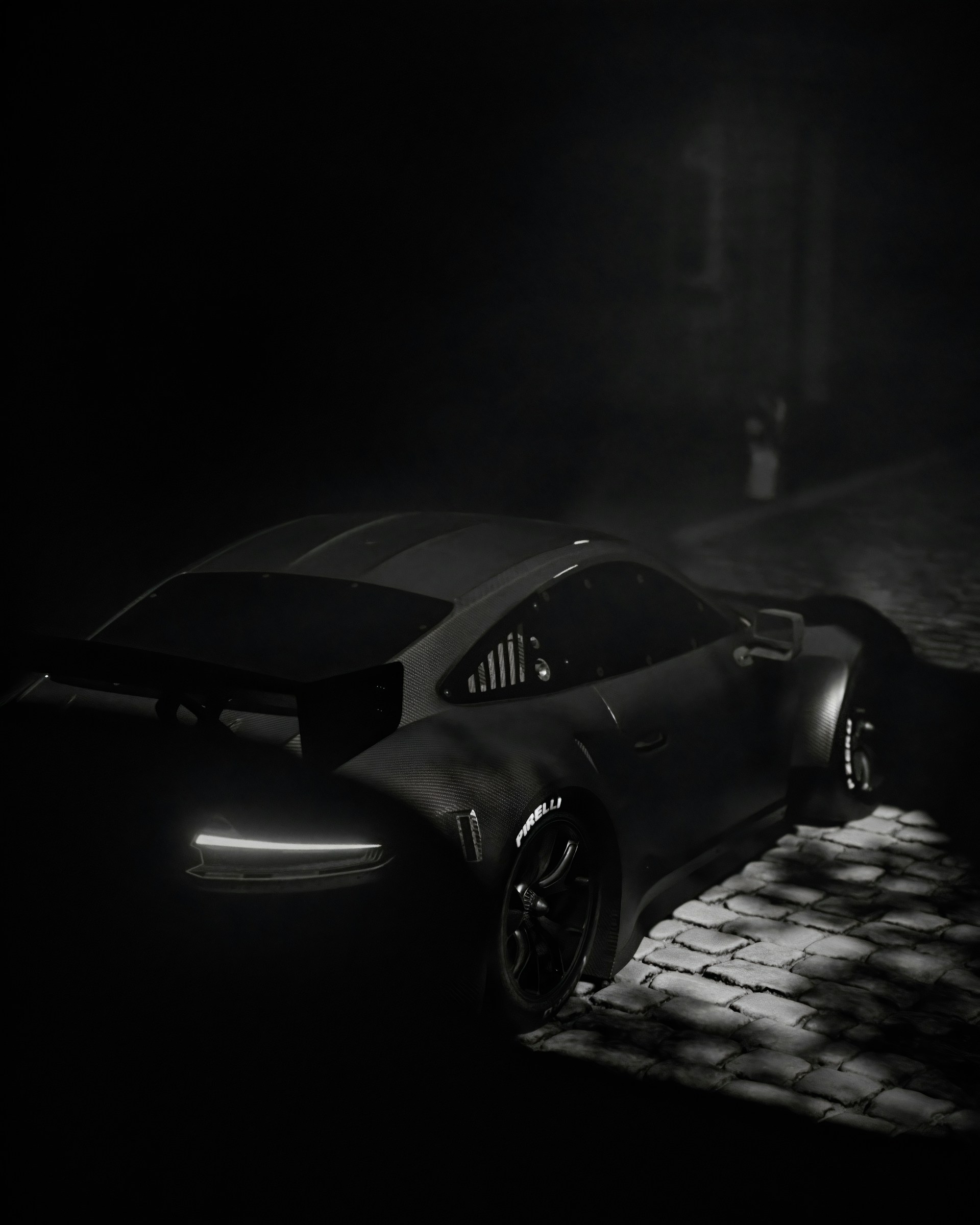 a car parked in the dark on a cobblestone street
