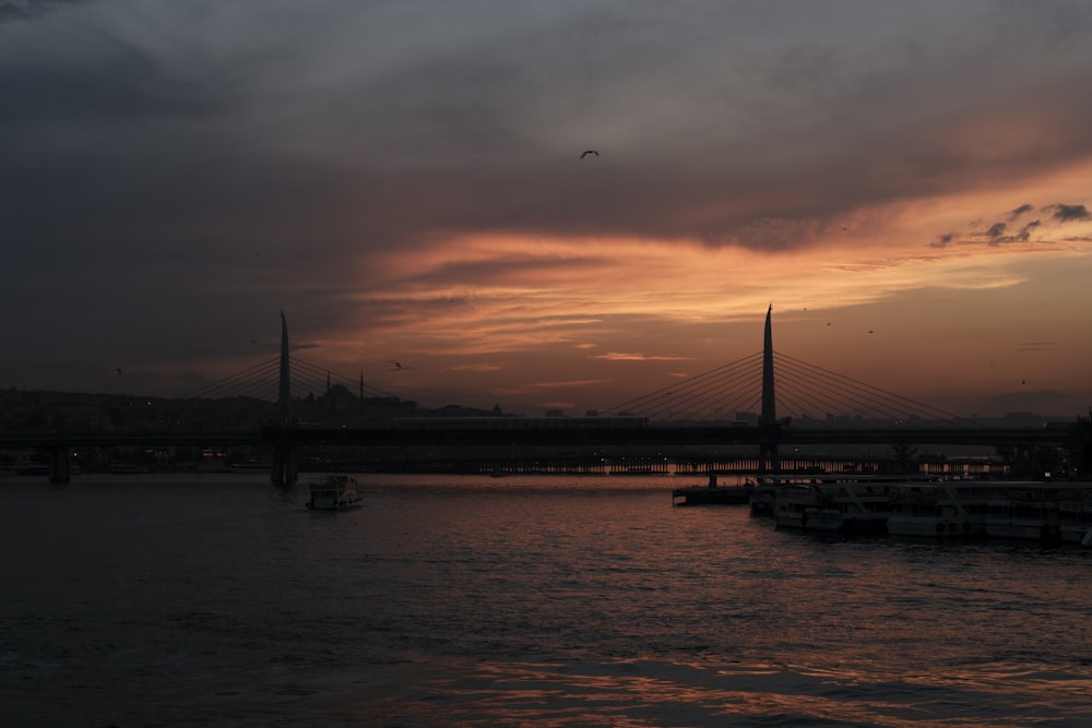 a body of water with a bridge in the background