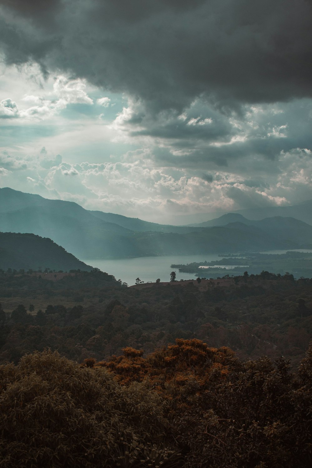 a view of a mountain range with a body of water in the distance