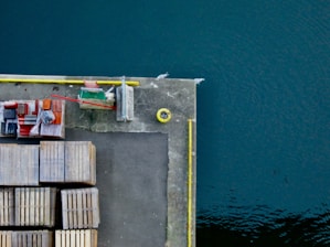 A marine dock with workers inspecting concrete structures and equipment.